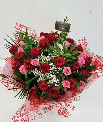 Roses Galore - Red and Pink roses in a handtied bouquet with gyp and foliages